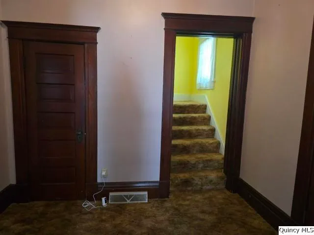 a view of a hallway with wooden door