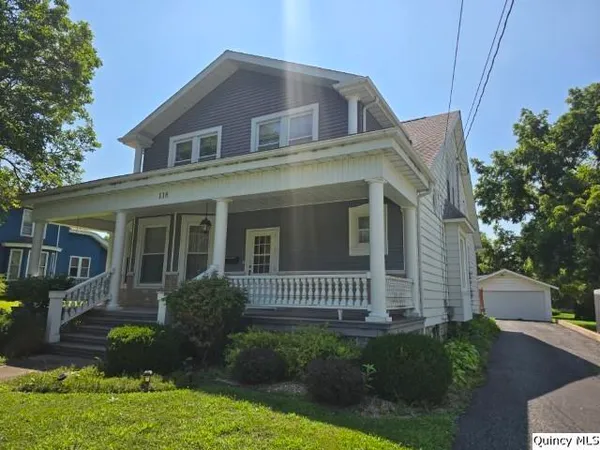 a view of a house with backyard and porch