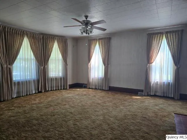 an empty room with windows and entrance