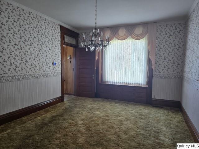 118 South Fayette Street Carthage, IL 62321 - Photo 5 of 32 an empty room with windows and chandelier