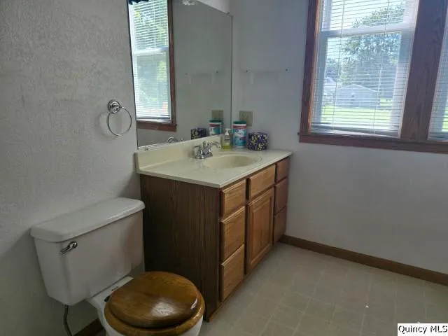 a bathroom with a sink toilet and mirror