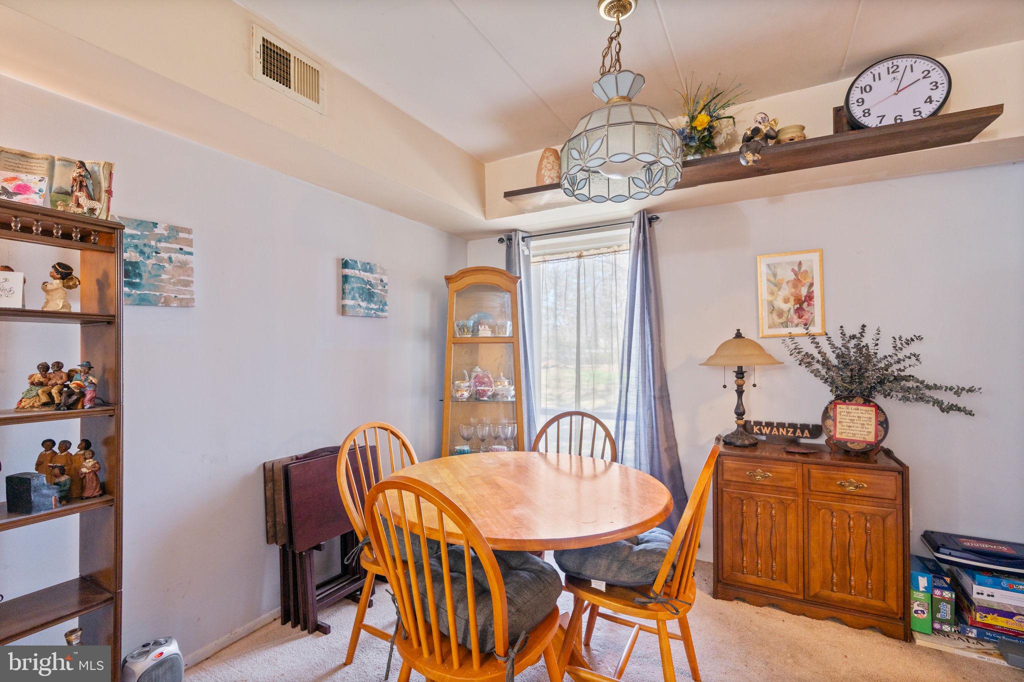 5382 Smooth Meadow Way, Unit 4 Columbia, MD 21044 - Photo 11 of 23 a dining room with furniture a chandelier and wooden floor