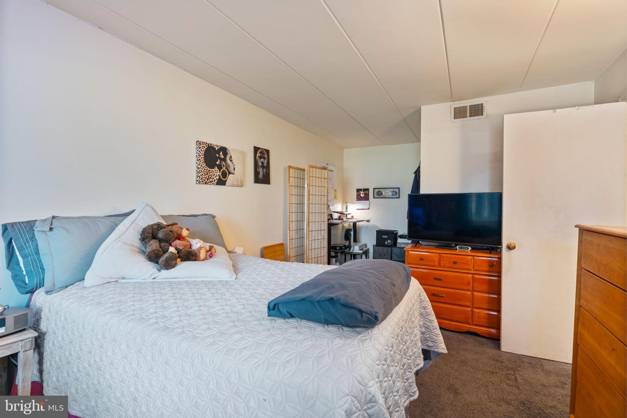 5382 Smooth Meadow Way, Unit 4 Columbia, MD 21044 - Photo 15 of 23 a bedroom with a bed and flat screen tv