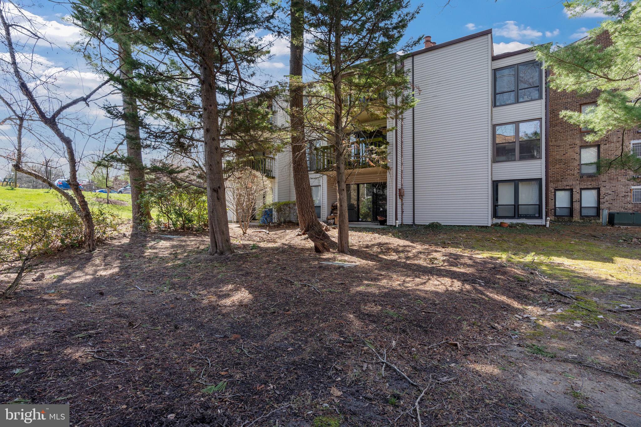 5382 Smooth Meadow Way, Unit 4 Columbia, MD 21044 - Photo 20 of 23 a view of a house with backyard and trees
