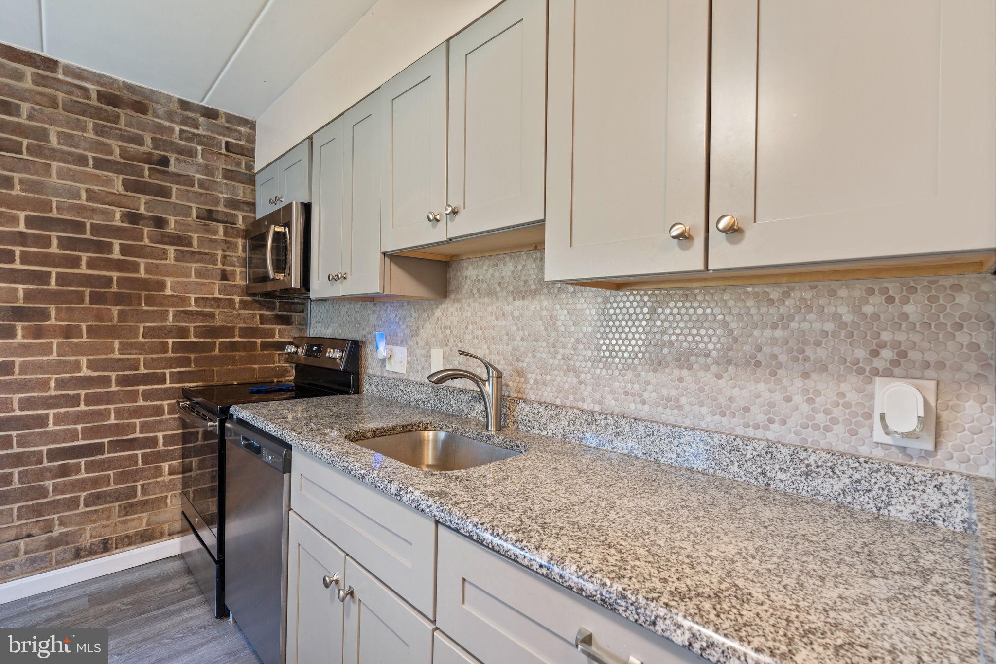 5382 Smooth Meadow Way, Unit 4 Columbia, MD 21044 - Photo 4 of 23 a kitchen with a sink cabinets and utility