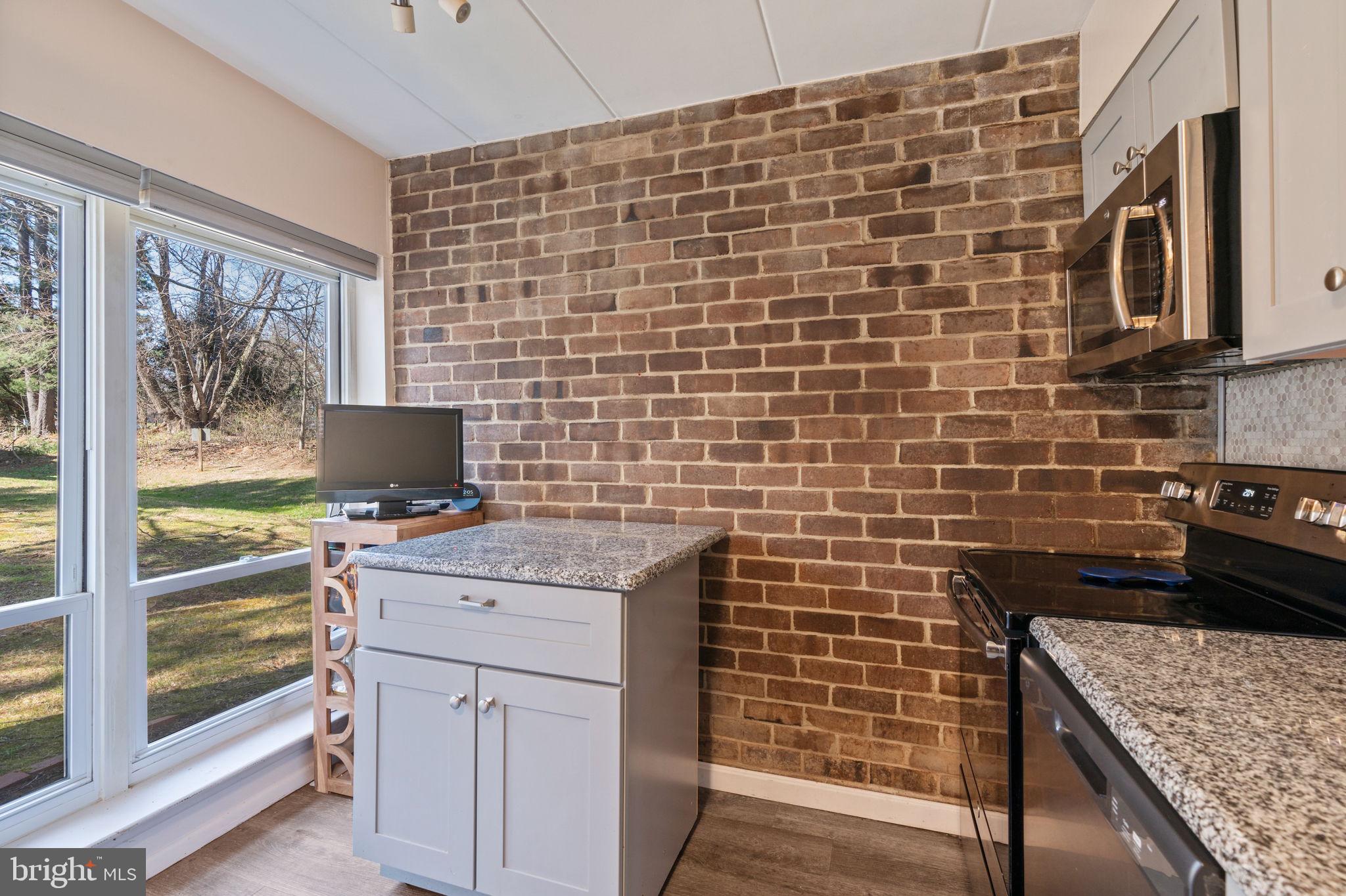 5382 Smooth Meadow Way, Unit 4 Columbia, MD 21044 - Photo 7 of 23 a kitchen with stainless steel appliances wooden cabinets a stove and a refrigerator