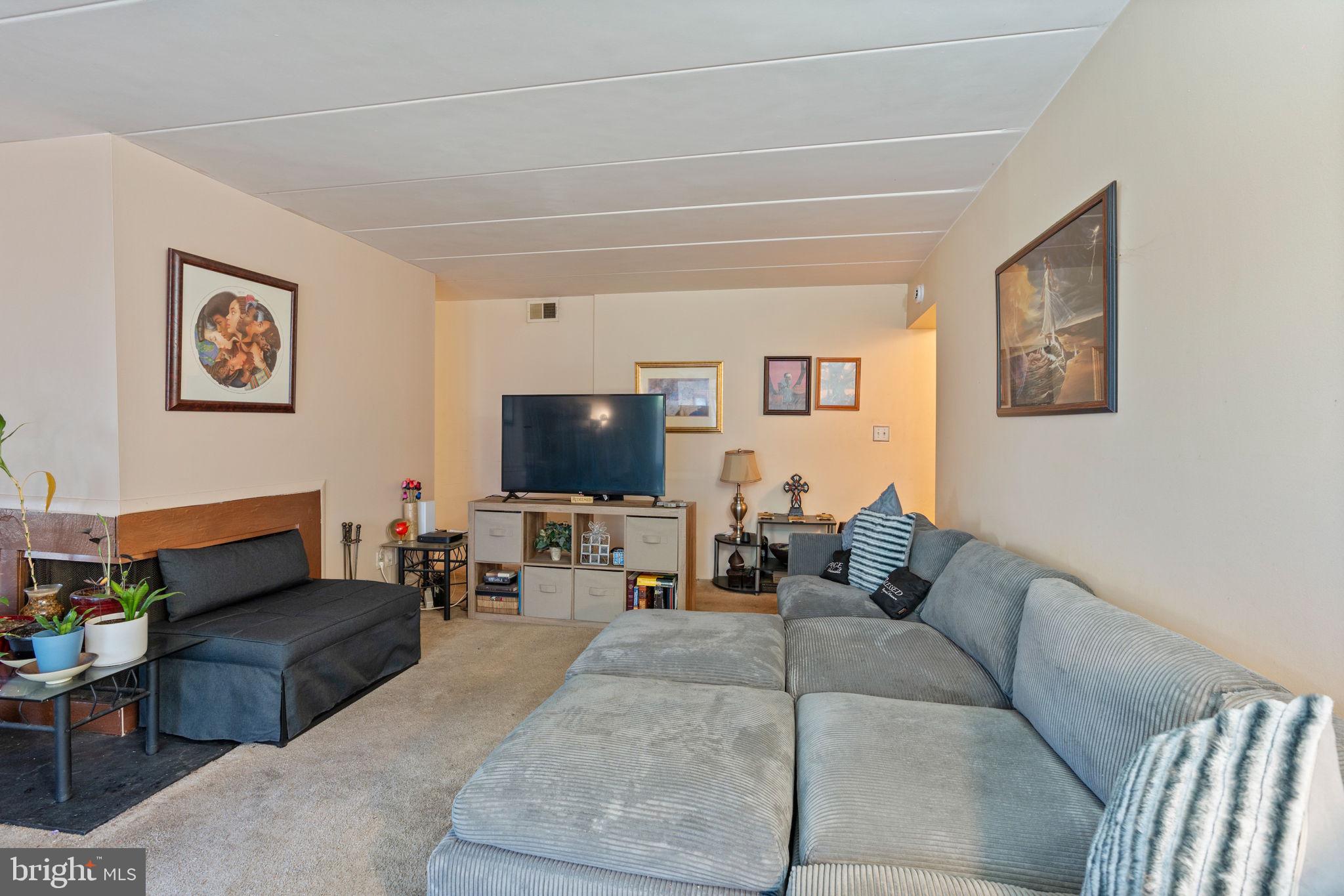 5382 Smooth Meadow Way, Unit 4 Columbia, MD 21044 - Photo 9 of 23 a living room with furniture and a flat screen tv