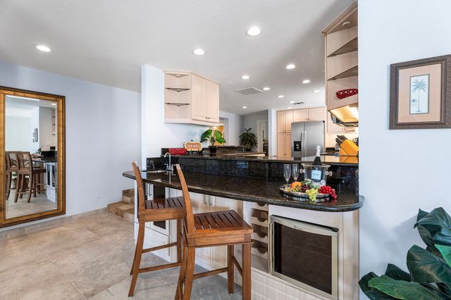 a kitchen with a sink cabinets and stove top oven