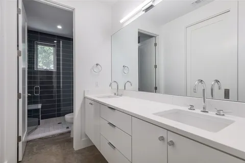 a bathroom with a sink double vanity and a shower