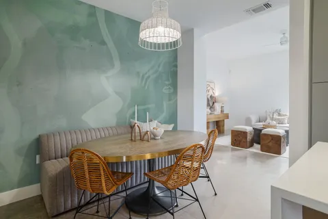 a view of a dining room with furniture and chandelier