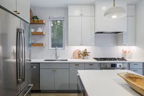 a kitchen with a sink a stove and refrigerator