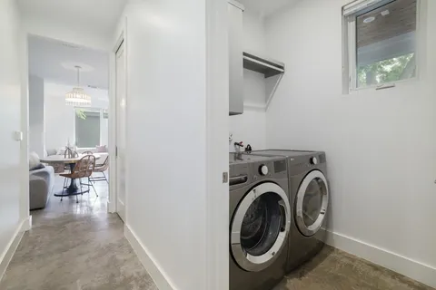 a view of a hallway with washer and dryer