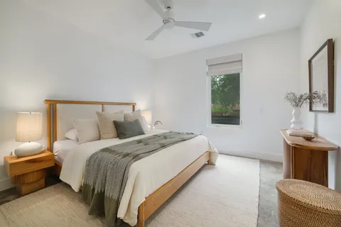a bed room with a bed and a potted plant