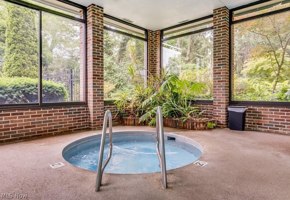 2365 Covington Road, Unit 425 Akron, OH 44313 - Photo 17 of 19 The hot tub/whirlpool area is surrounded by large windows and lush landscaping. You can also relax on the patio areas surrounding the community area.