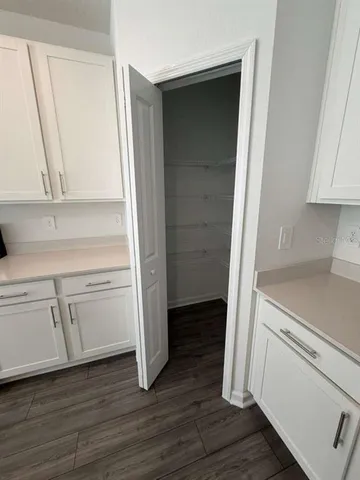 a kitchen with white cabinets and a sink