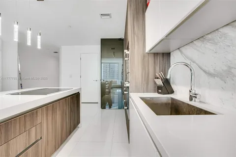 a kitchen with a sink and a refrigerator