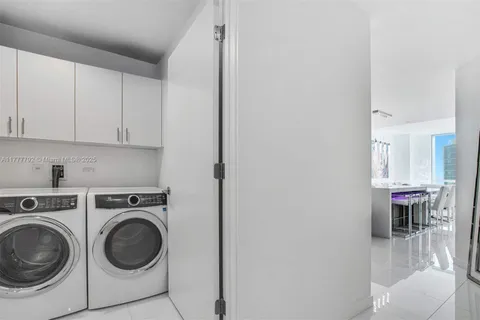 a view of a hallway with washer and dryer
