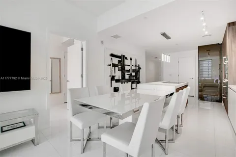 a large kitchen with a table and chairs