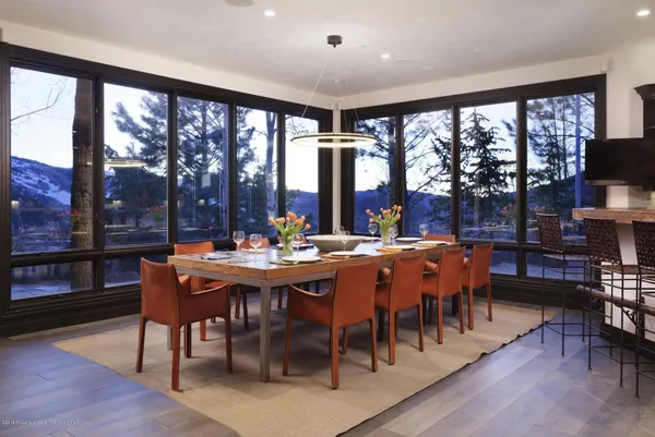 a view of a dining room with furniture window and wooden floor