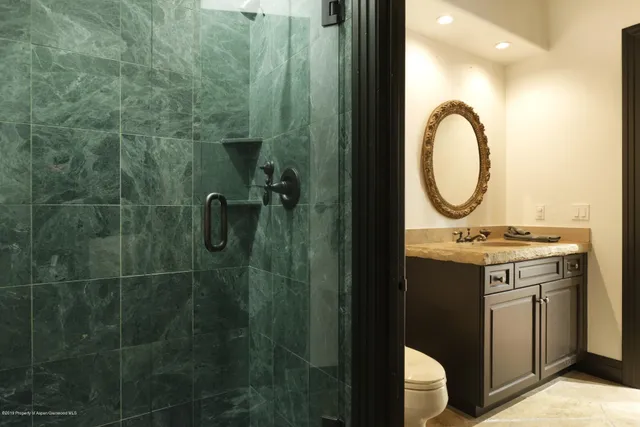 a bathroom with a sink mirror vanity and toilet