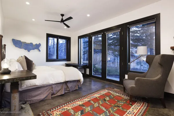 a bed sitting in a bedroom next to a window