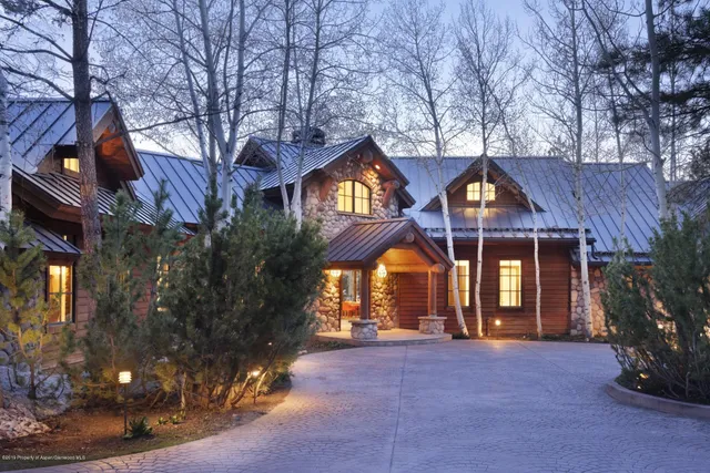 a front view of house with a garden