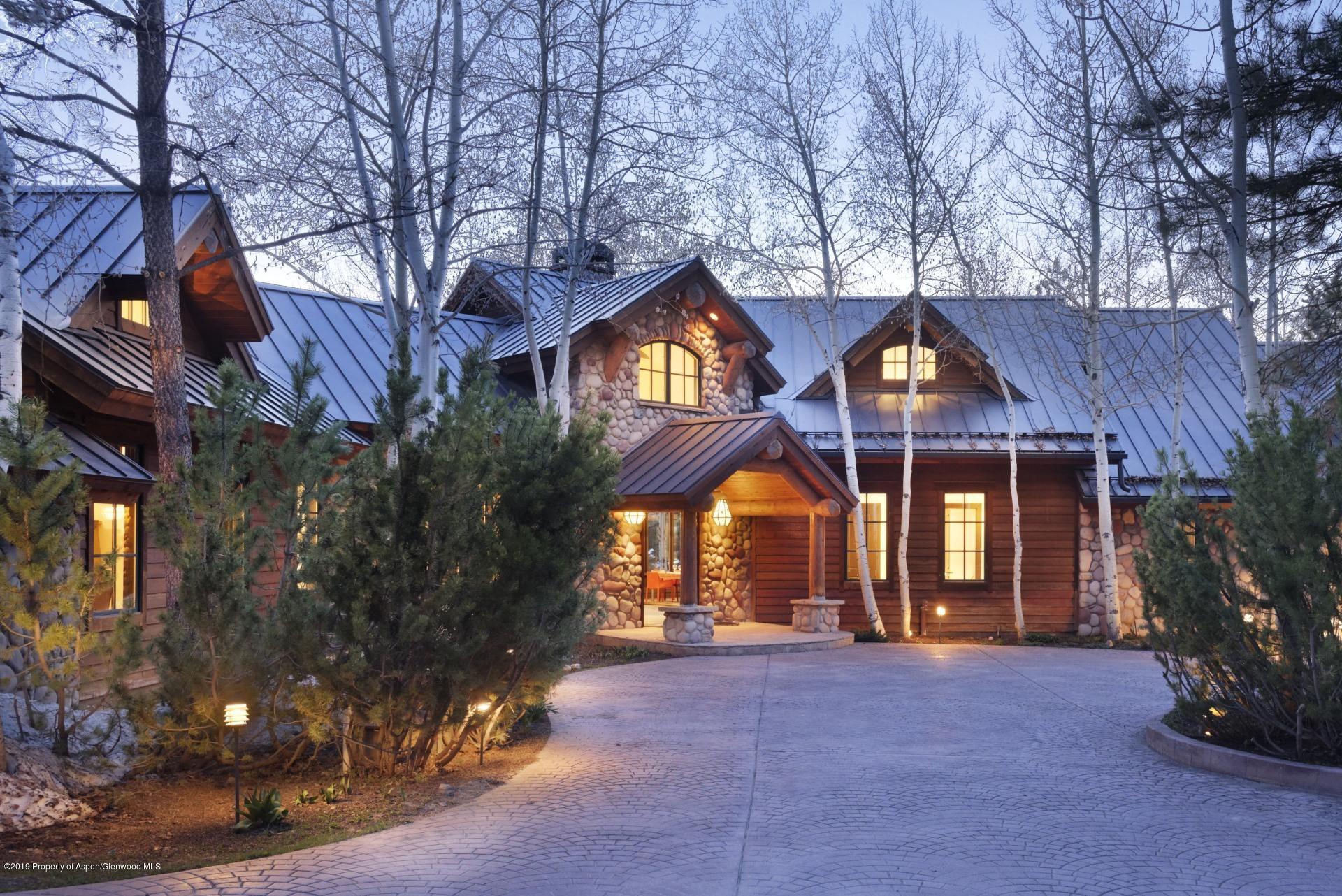 450 Smuggler Mountain Road Aspen, CO 81611 - Photo 2 of 37 a front view of house with a garden