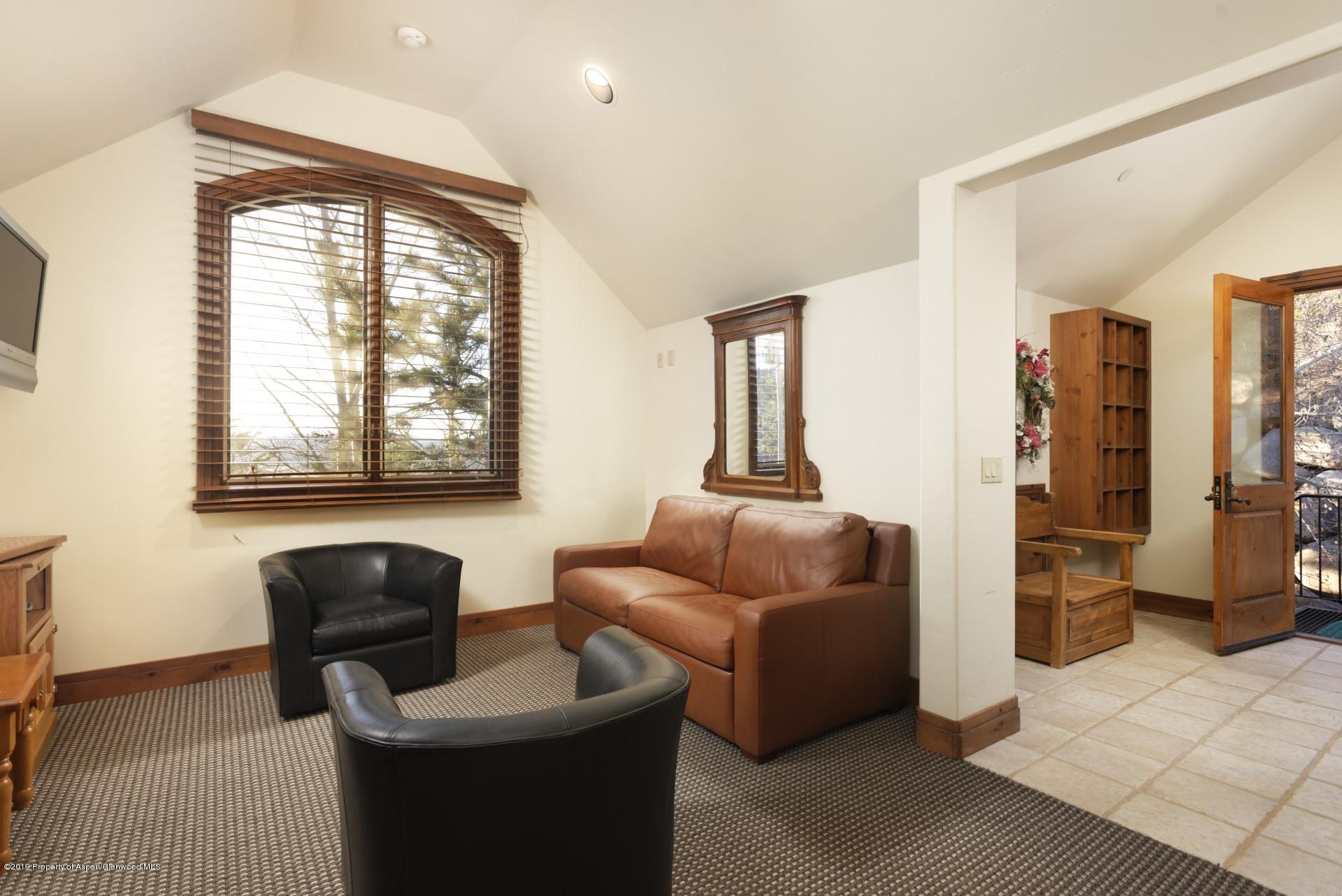 450 Smuggler Mountain Road Aspen, CO 81611 - Photo 28 of 37 a living room with furniture and a large window