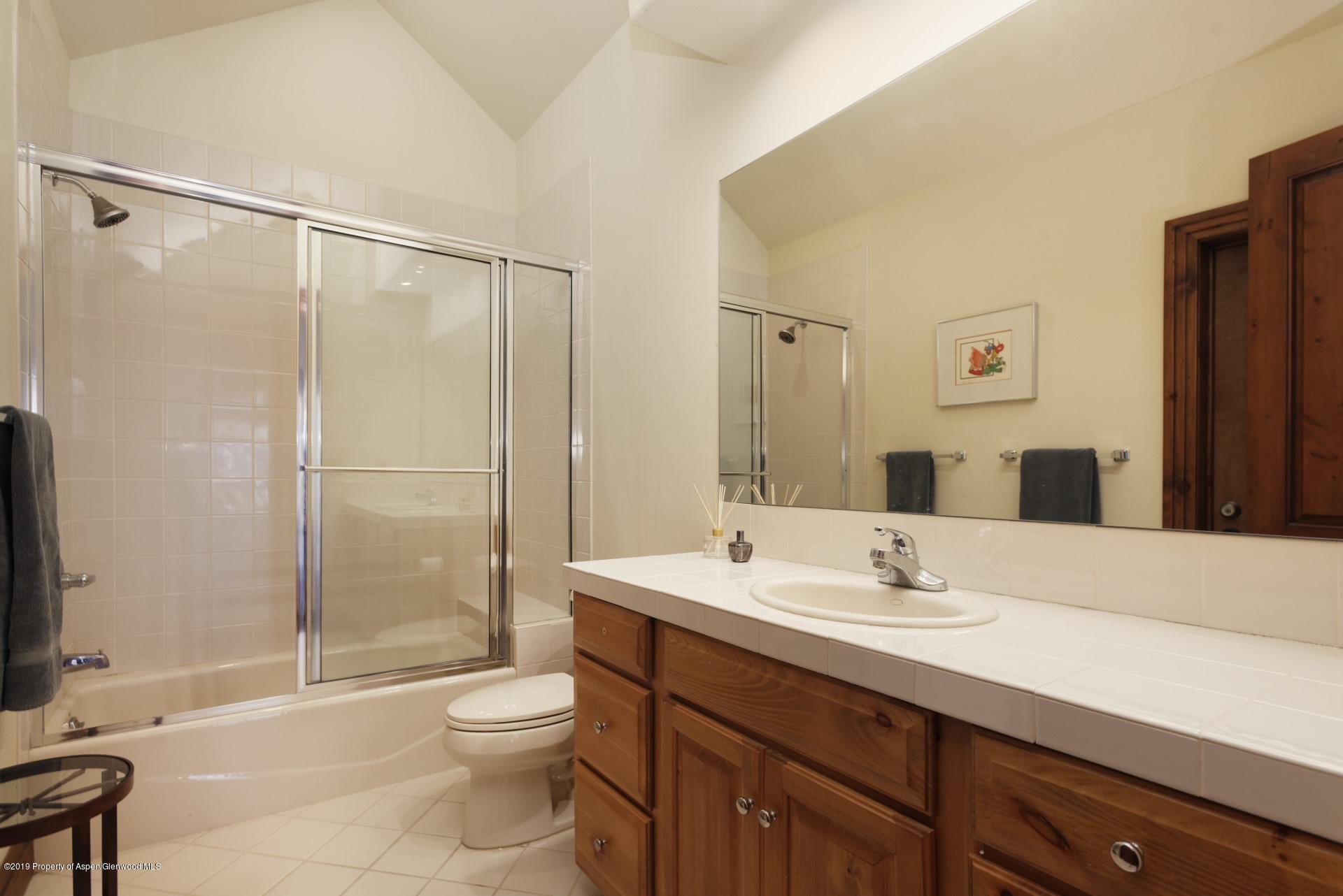 450 Smuggler Mountain Road Aspen, CO 81611 - Photo 31 of 37 a bathroom with a shower sink vanity mirror and toilet