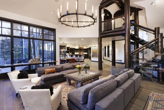 a living room with furniture a rug and a chandelier