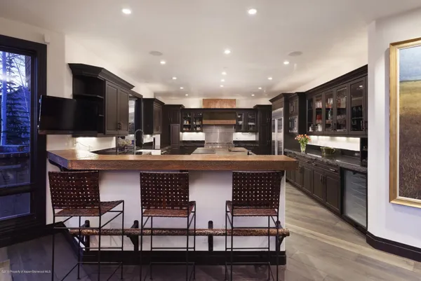 a kitchen with a kitchen island hardwood floor and a sink