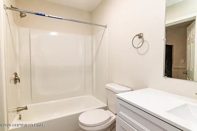 a bathroom with a sink a toilet and a shower