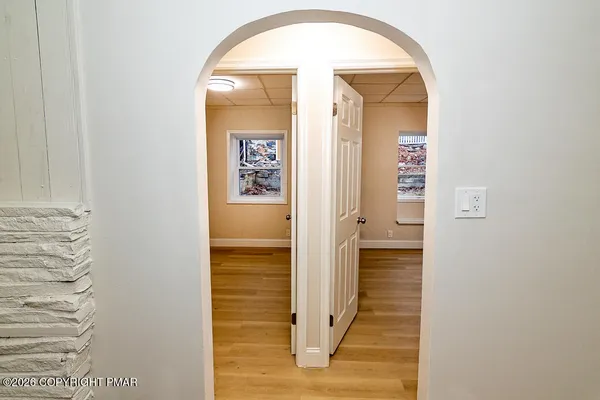 a view of a hallway with wooden floor
