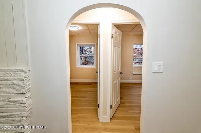 a view of a hallway with wooden floor