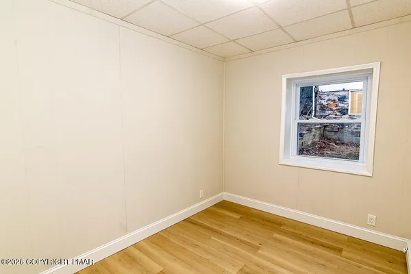 a view of a room with wooden floor and wall painting