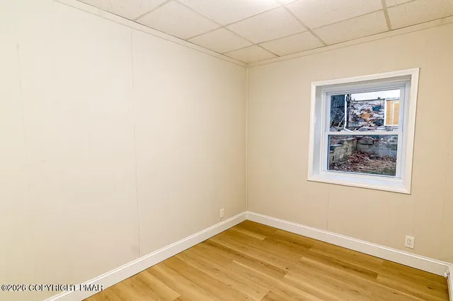 a view of a room with wooden floor and wall painting