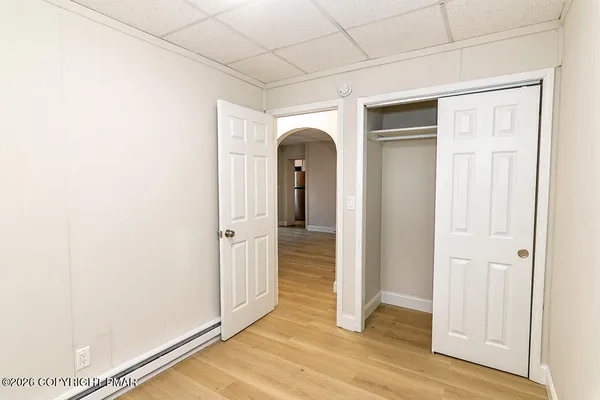a view of a room that has a door and wooden floor