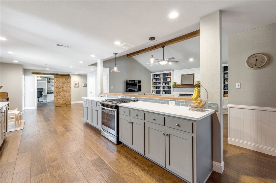104 Highview Road Georgetown, TX 78628 - Photo 5 of 16 a large kitchen with stainless steel appliances granite countertop a lot of counter space and wooden floors