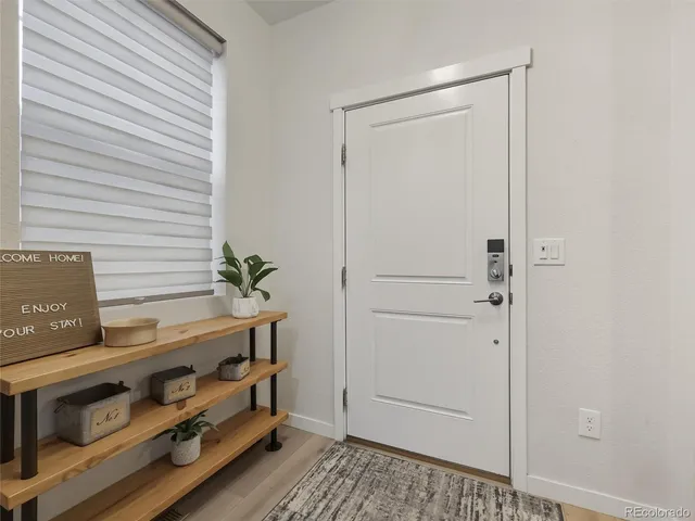 a view of an entryway with wooden floor