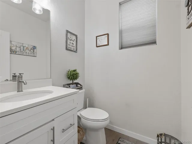 a bathroom with a sink mirror and toilet