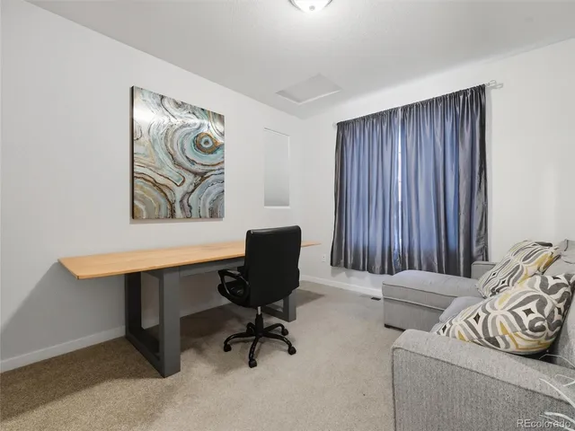 a view of a livingroom with workspace and a couch