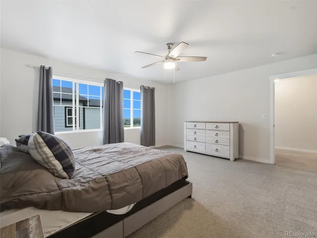 a bedroom with a large bed and a chandelier