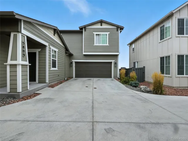 a front view of a house with garage