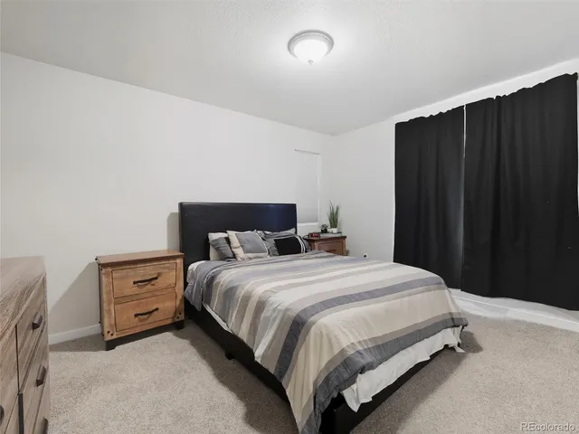 a bedroom with a bed and wooden closet