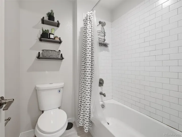 a bathroom with a toilet and a bathtub