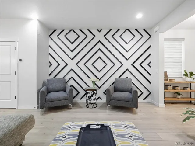 a living room with furniture and ceiling fan