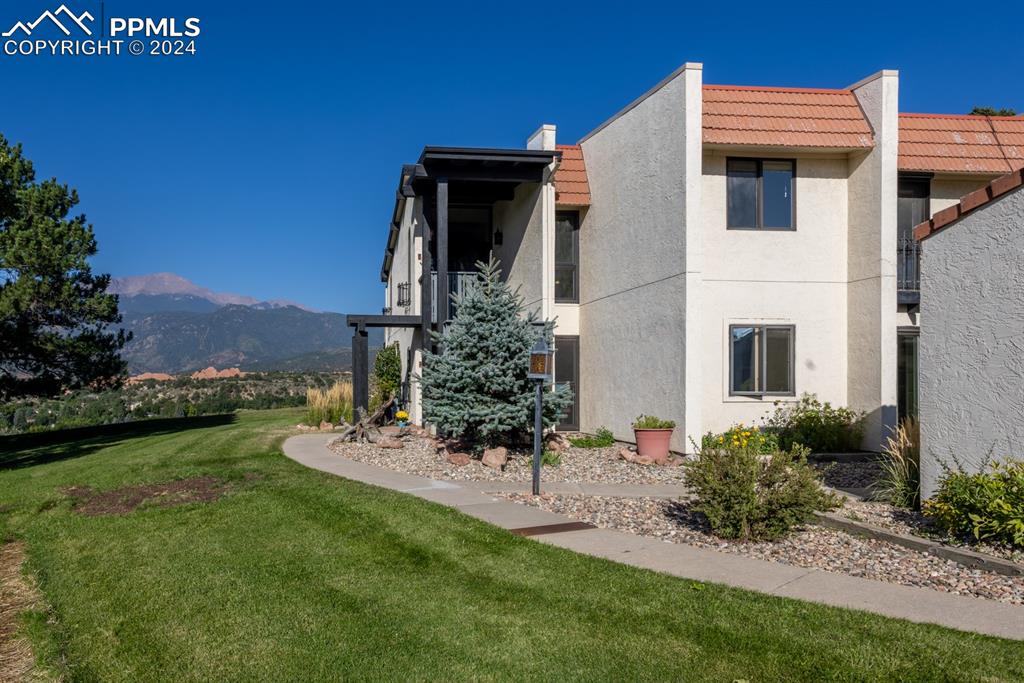 View of front of property featuring a mountain view and a yard