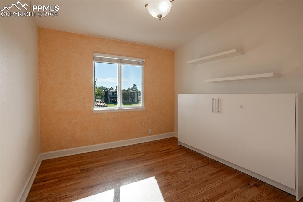 1074 Fontmore Road, Unit C Colorado Springs, CO 80904 - Photo 16 of 30 Second bedroom featuring hardwood / wood-style flooring, vaulted ceiling, and Murphy bed