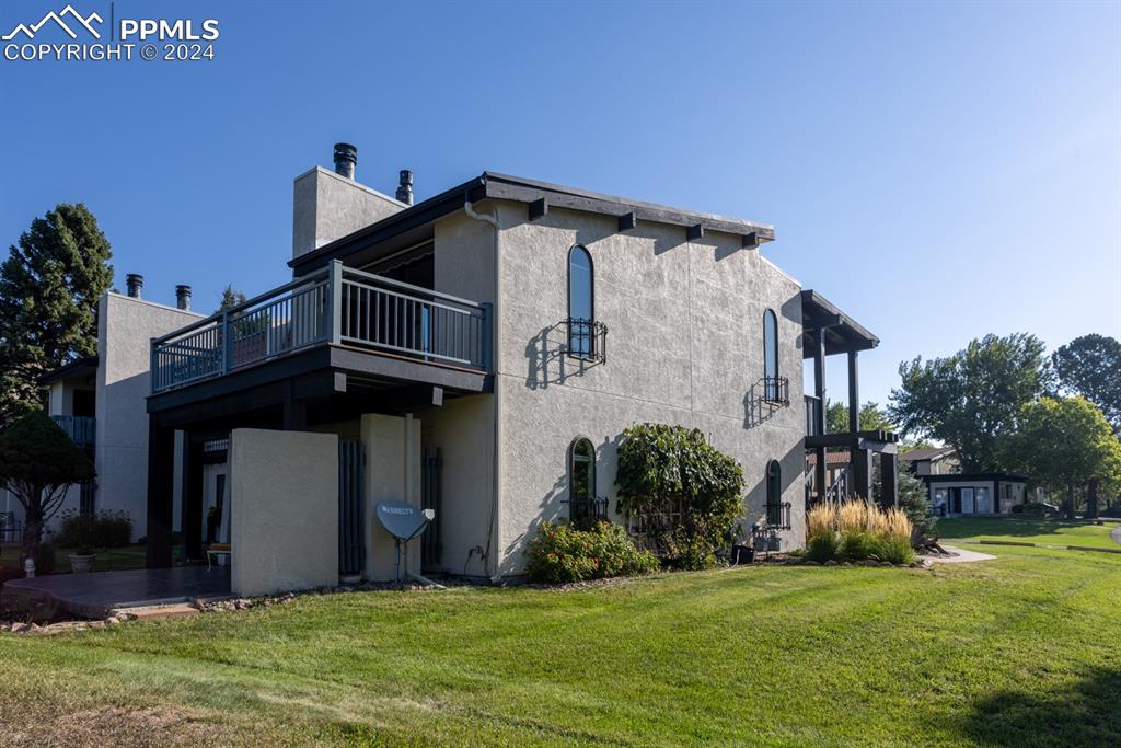 1074 Fontmore Road, Unit C Colorado Springs, CO 80904 - Photo 2 of 30 Side of property featuring a deck and a lawn