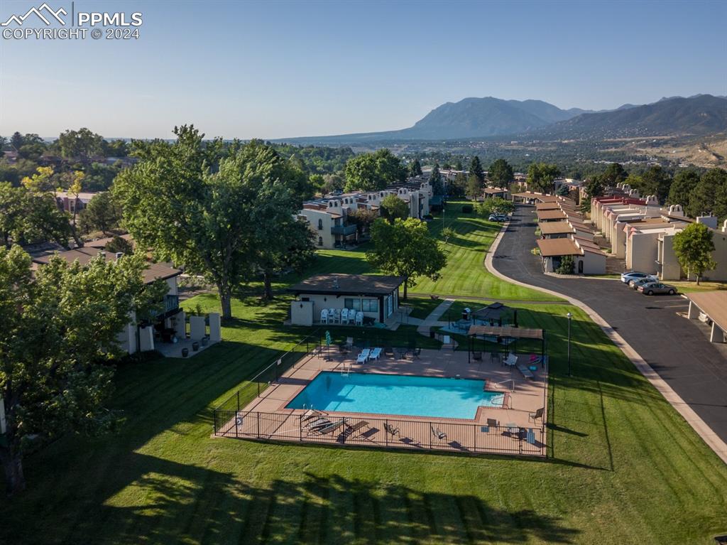 1074 Fontmore Road, Unit C Colorado Springs, CO 80904 - Photo 30 of 30 Pool featuring a lawn, a mountain view, and a patio area